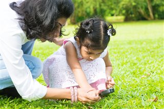 Mom encouraging her toddler to explore.