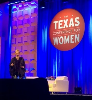 Brene Brown standing at the conference.